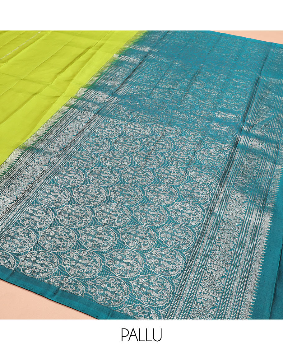Borderless green zari buttas Kanchipuram silk saree, contrast pallu of thilakam mokku, banaras, muthu, rudraksham, annam, and floral-bird motifs