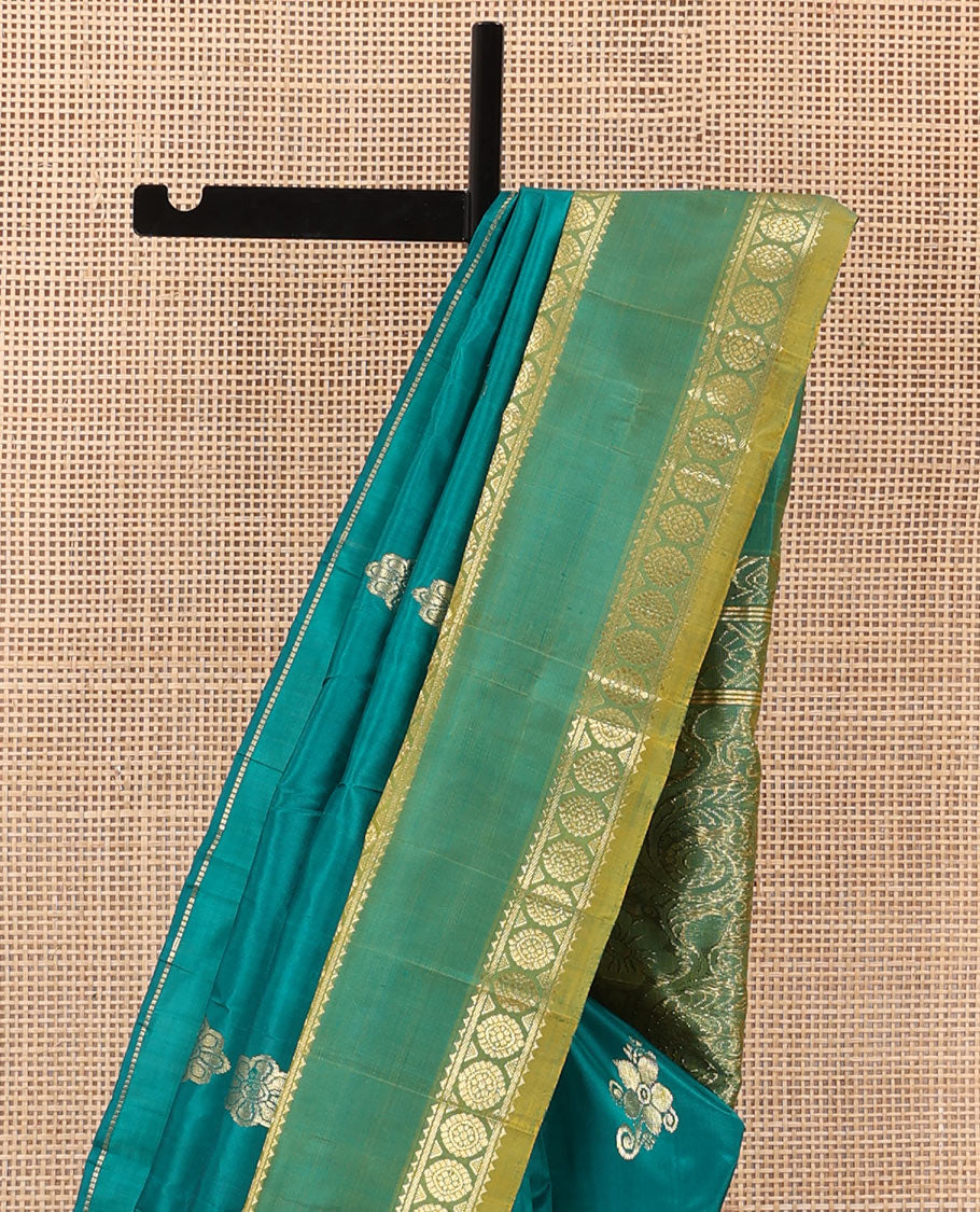 Green zari buttas Kanchipuram silk saree, contrast one-sided rettai pettu border of rekku, and laddu kamalam, and floral design pallu