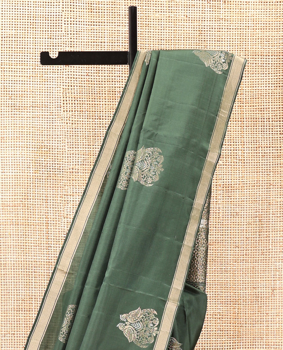 Green Mayuri Soft Silk Saree, Entralled with Zari Buttas All Over Its Body Highlighted iby Zari Piping Border, Intricately Designed Pallu and Paired with a Matching Blouse