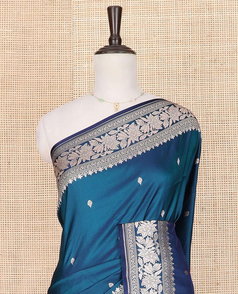 Blue zari buttas mushru silk saree, self-border of floral creeper designs, and flower vase buttas woven pallu