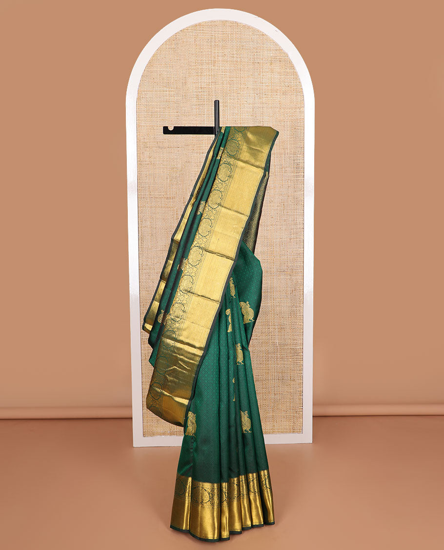 Dark green embossed & mayil buttas silk saree, self-border of thilakam mokku, muthu, poun, banaras design & jaal pallu
