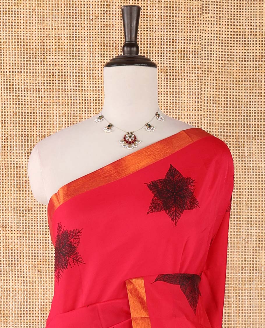 Red six-petal-like leaf motifs printed micro-silk saree, copper zari border, contrast intricate pallu & plain green blouse