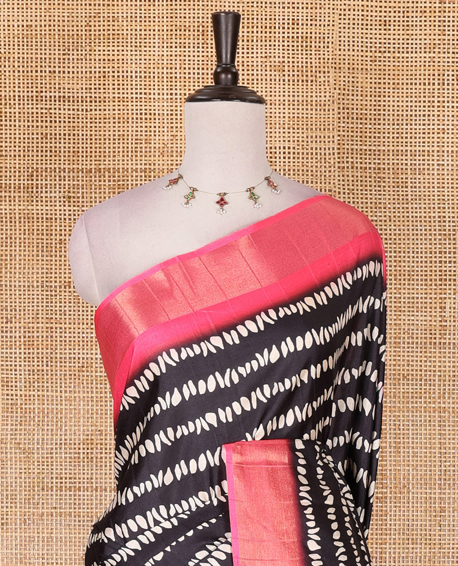 Black geometric patterns printed soft tussar saree, contrast bavanji border, kalamkari floral vine printed pallu, and printed blouse