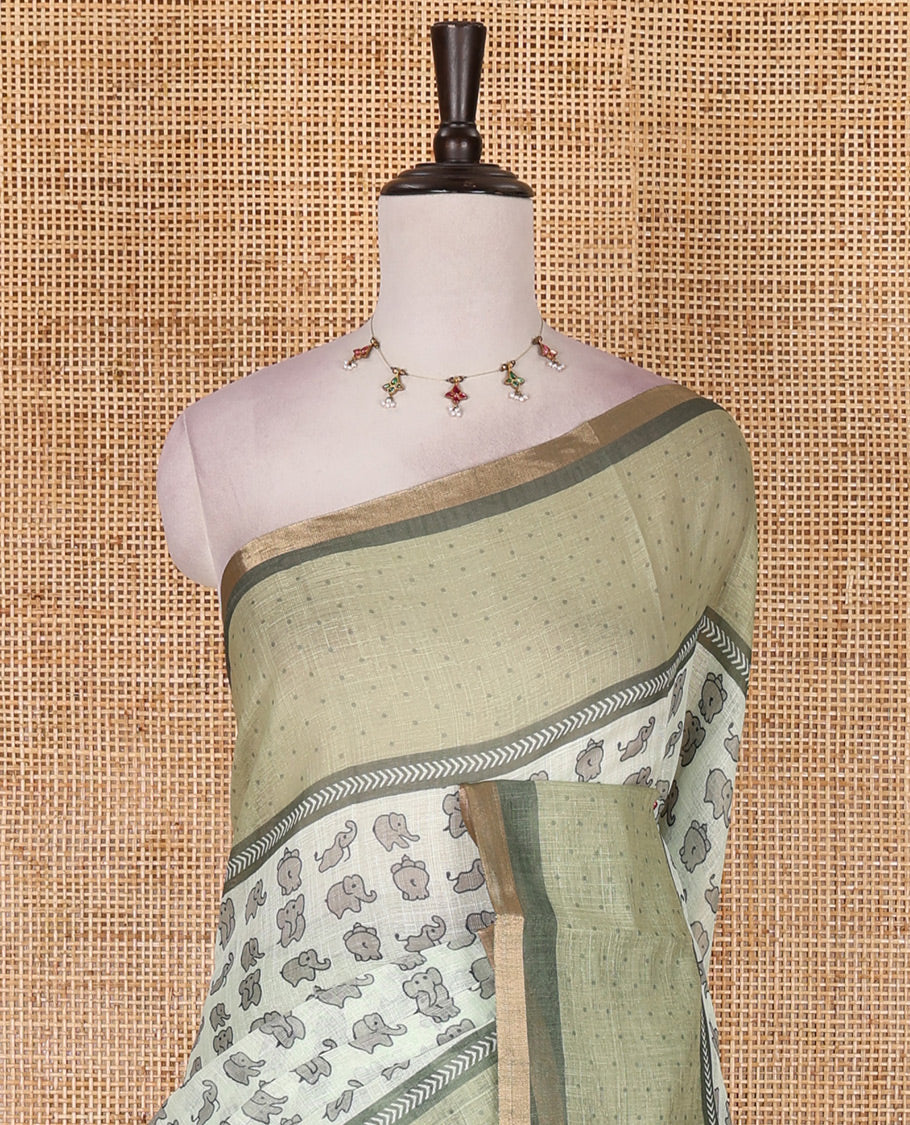 Green cute elephant motifs printed linen cotton saree, contrast chevron border, pallu of stripes and chevron, and contrast printed blouse