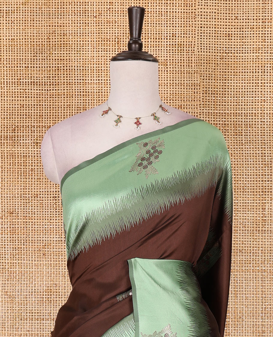 Brown-green floral buttas elite soft silk saree, contrast floral buttas border, and pallu of Mughal-style intricate zari designs