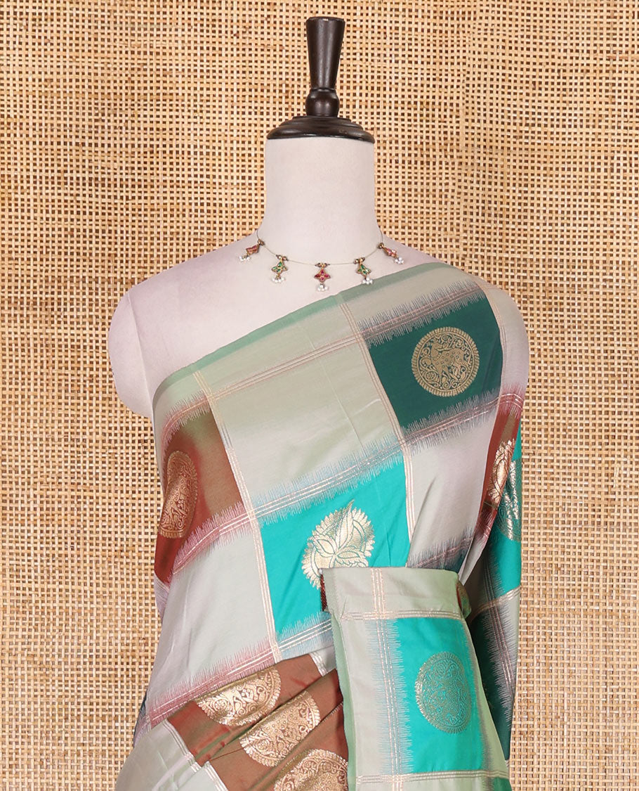 Borderless pista green chakra buttas enclosed, checked elite soft silk saree, contrast ogee patterned pallu, and contrast zari design blouse