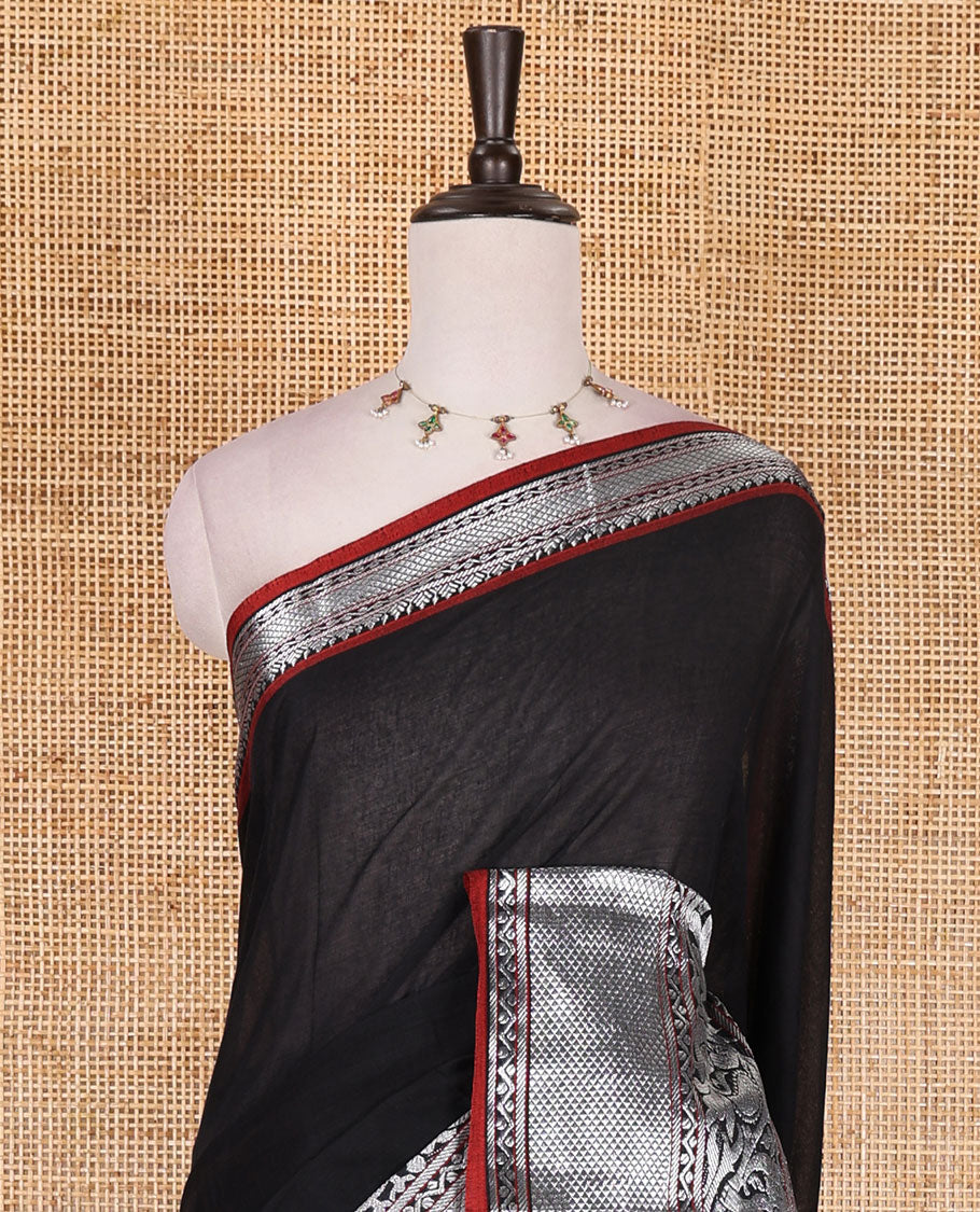 Black plain mercerised cotton saree, contrast traditional zari border of elephant and peacock designs, striped pallu, and plain blouse