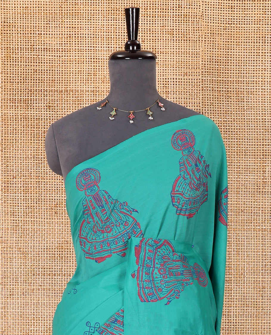 Borderless Blue kolam and kathakali motifs printed South cotton saree with a matching blouse, and a contrast floral motifs printed blouse