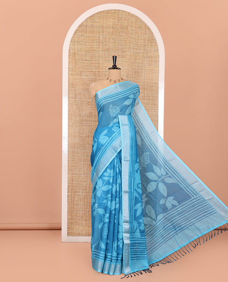 Blue Linen Cotton Saree, Beautified with Floral Leaf Motifs Printed on Its Body, Subtle Bavanji Border, Pallu Features Floral Print and Stripes, and Paired with a Matching Blouse