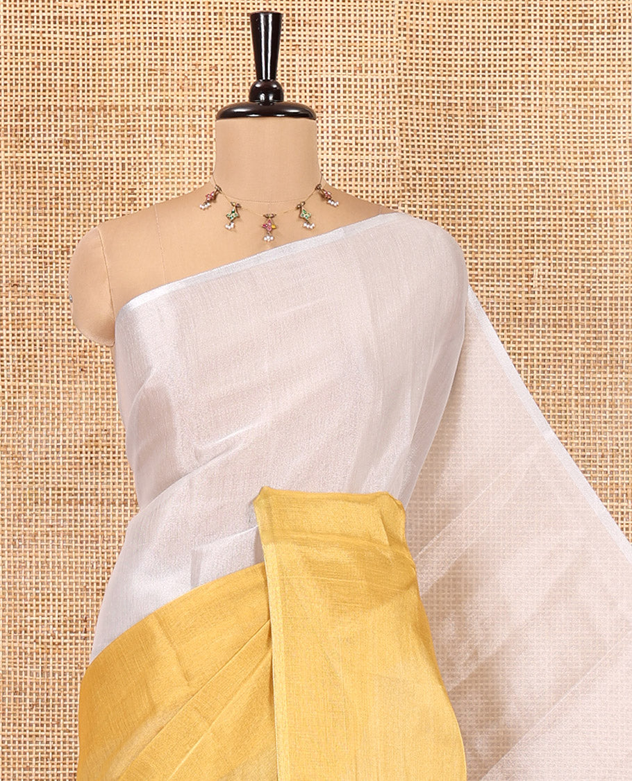 Borderless Yellow Plain Tissue Saree, a Self-Pallu with Tassels, and a Matching Blouse