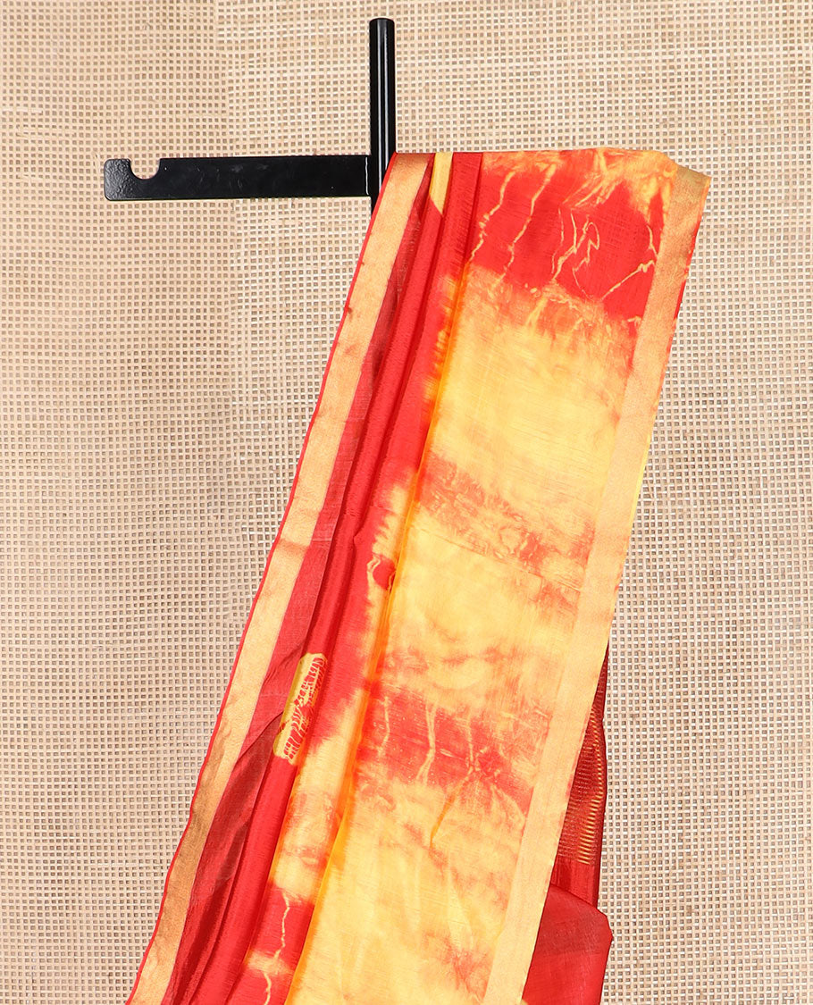Red and yellow shibori printed banana pith saree, zari piping border, and zari striped pallu
