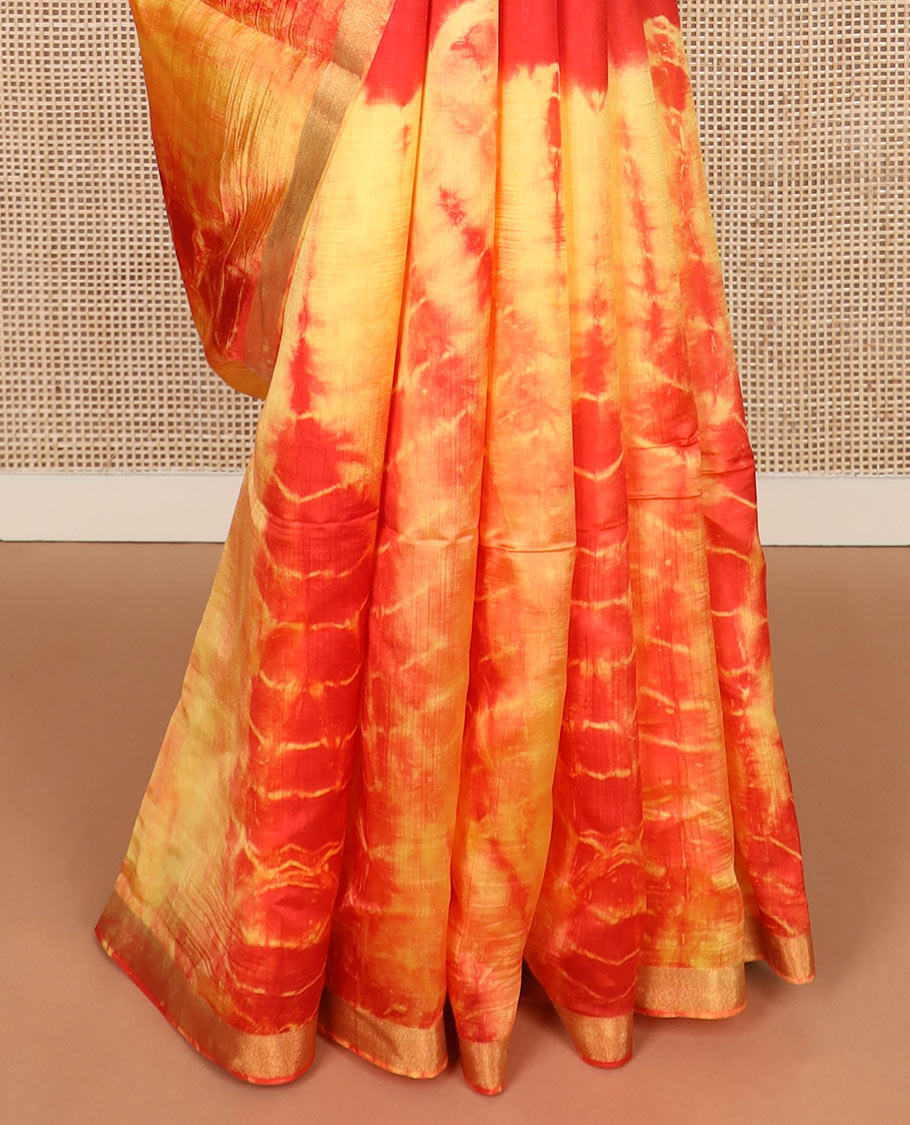 Red and yellow shibori printed banana pith saree, zari piping border, and zari striped pallu