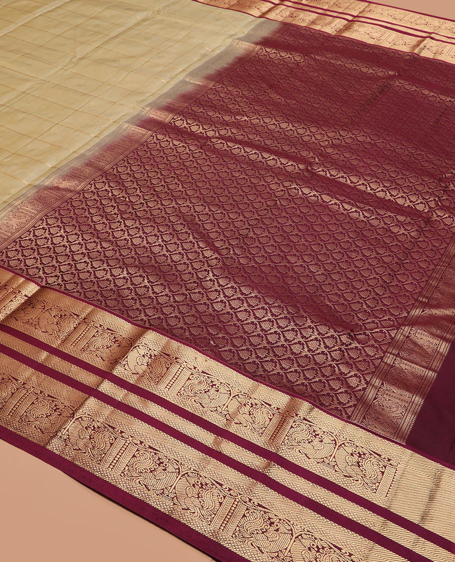 Light gold zari buttas and checked silk saree, contrast border of banaras, mayil kann, and mayil designs, and zari-rich jaal pallu