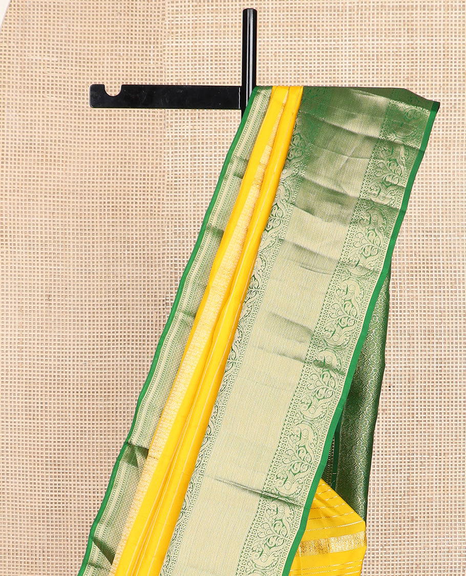 Yellow zari design silk saree, contrast border of reeku, lavangam, and kili designs, and ogee patterned pallu
