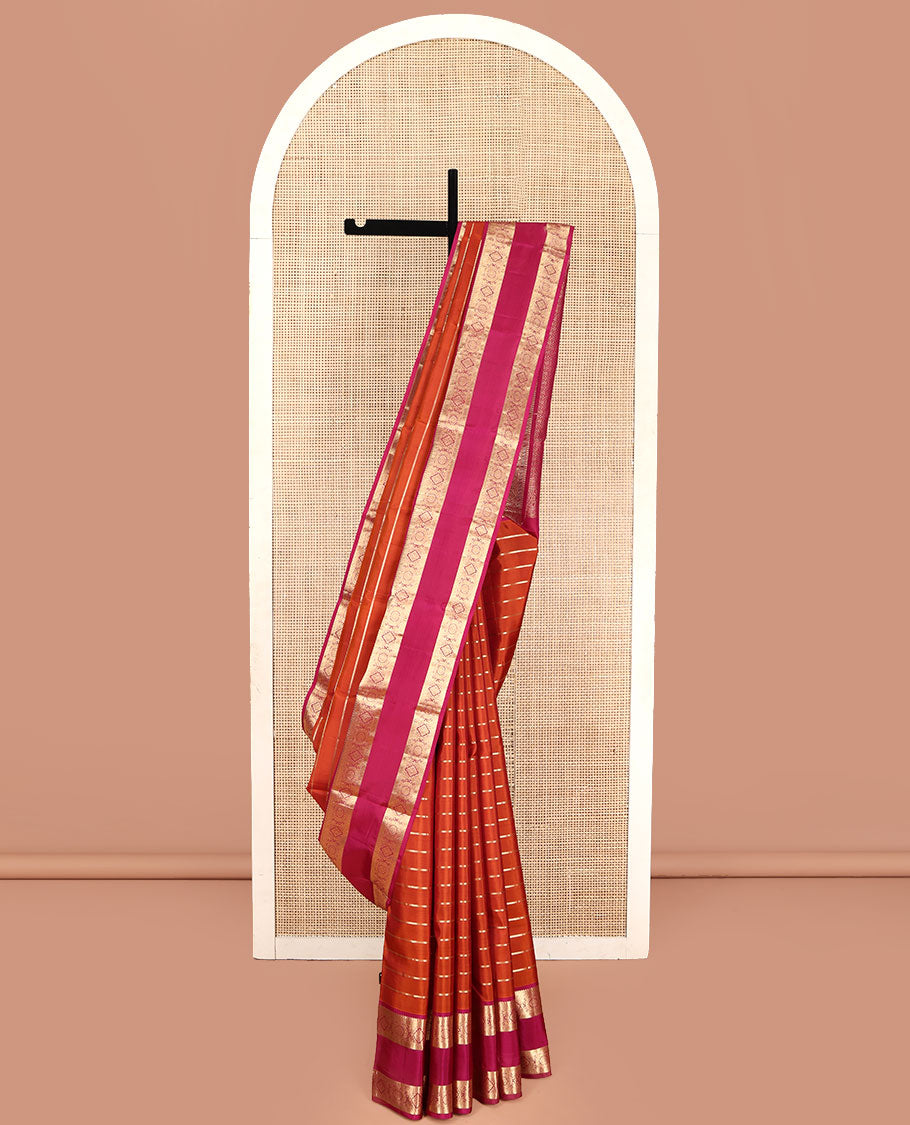 Orange Vasundhara Silk Saree, Richly Detailed with Zari Stripes All Over Its Body, Complemented by Contrast Rettai Pettu Border of Manga, Muthu, Diamond and Chakram Designs, Intricately Zari Detailed Pallu, and Paired with a Contrast Blouse