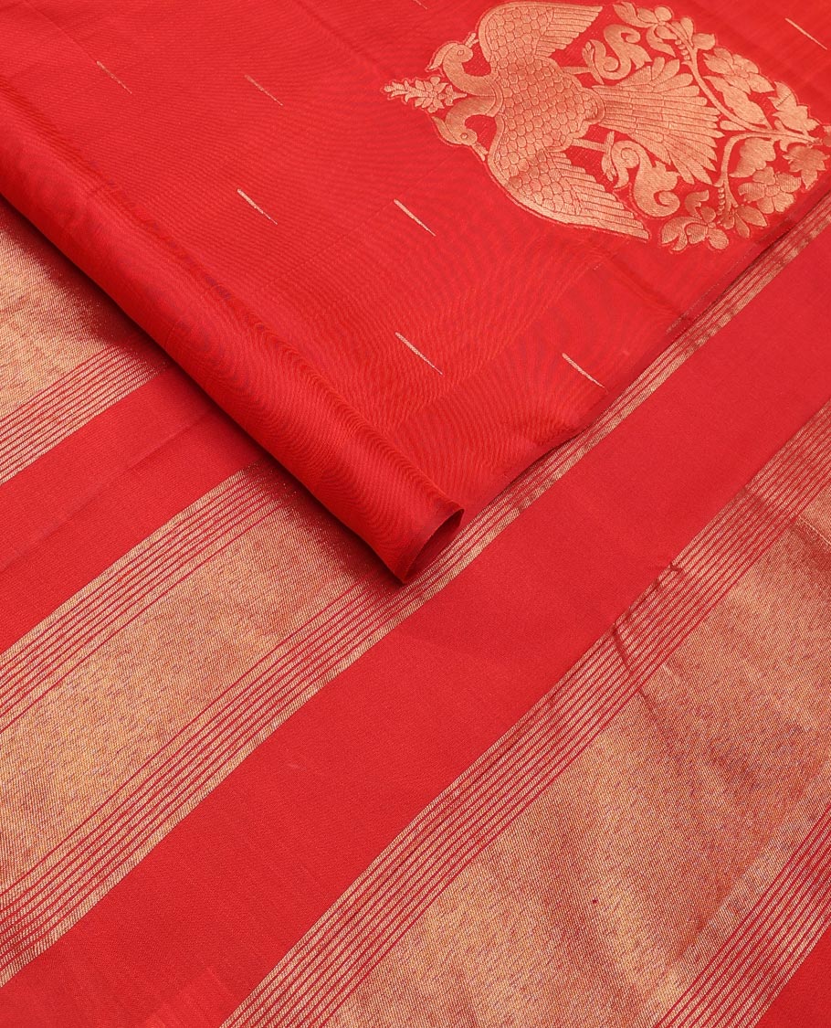 Borderless red silk saree with malli mokku and iruthalai pakshi buttas, self-pallu of zari stripes