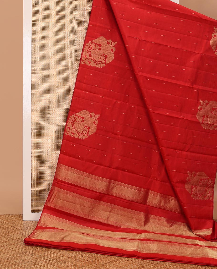 Borderless red silk saree with malli mokku and iruthalai pakshi buttas, self-pallu of zari stripes