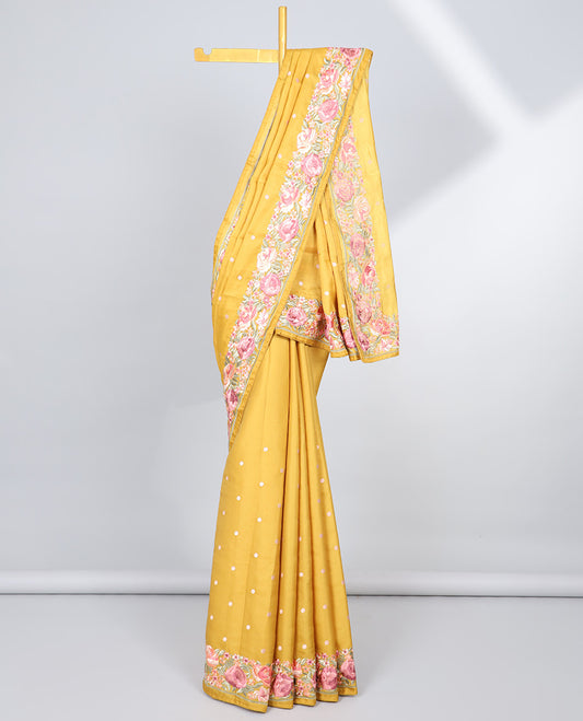 Yellow semi-banaras tussar saree with polka dots, colorful floral motifs thread embroidered border