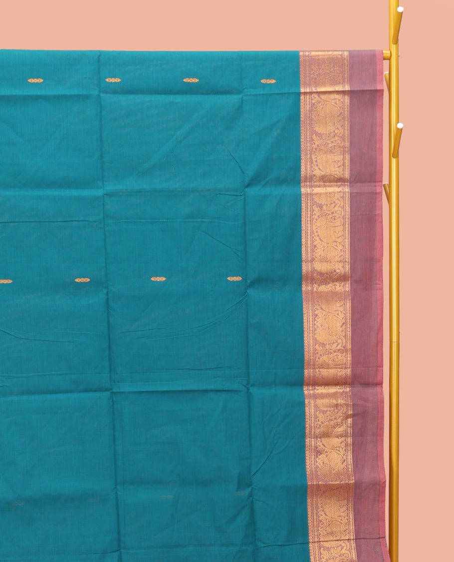 Blue Chettinad Cotton Saree, Bedecked with Thread Buttas All Over Its Body, Complemented by a Contrast Ganga-Jamuna Kal Eragina Border of Kodi Peacock and Elephant Designs, Pallu of Buttas and Stripes, and Paired with a Matching Blouse