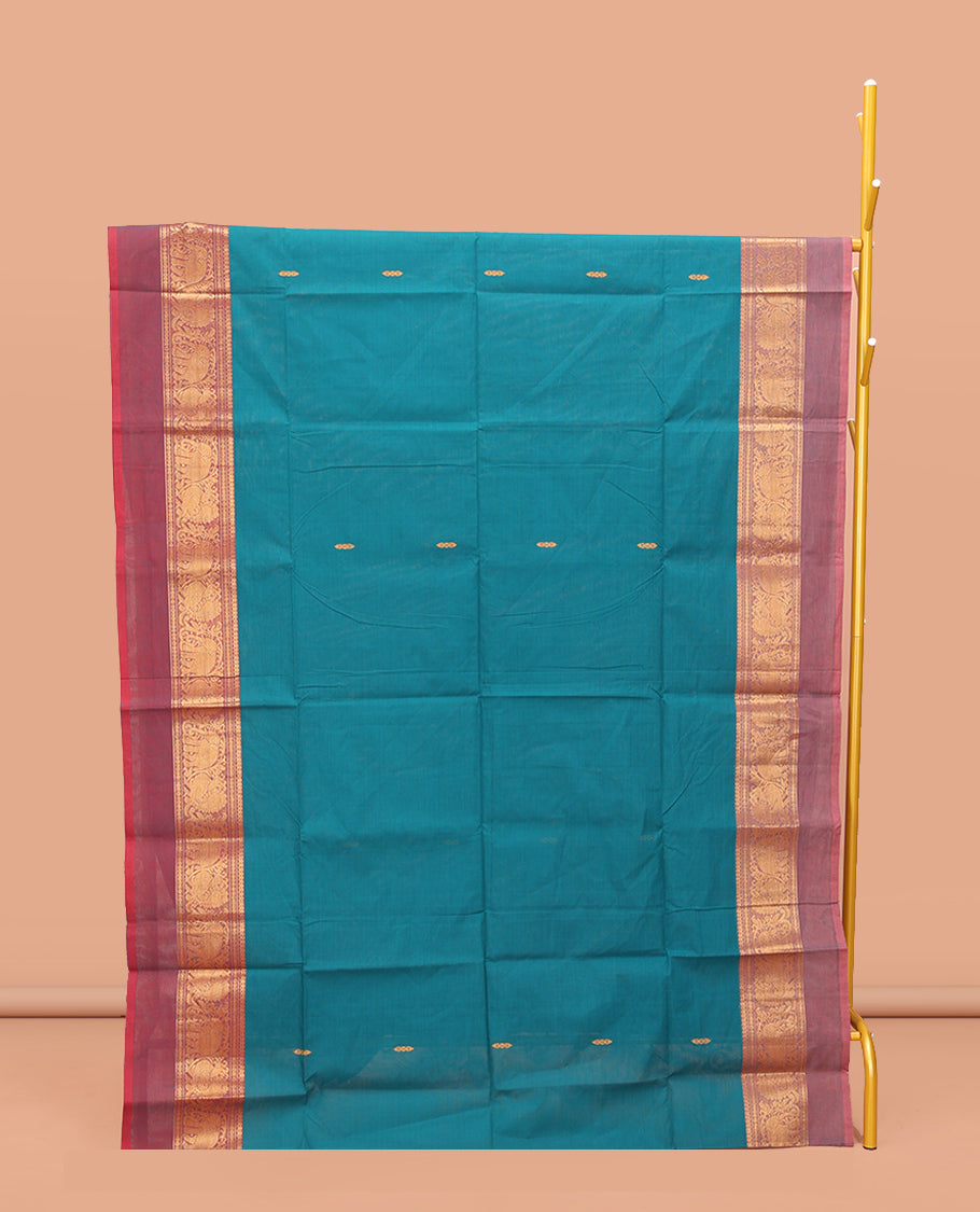 Blue Chettinad Cotton Saree, Bedecked with Thread Buttas All Over Its Body, Complemented by a Contrast Ganga-Jamuna Kal Eragina Border of Kodi Peacock and Elephant Designs, Pallu of Buttas and Stripes, and Paired with a Matching Blouse