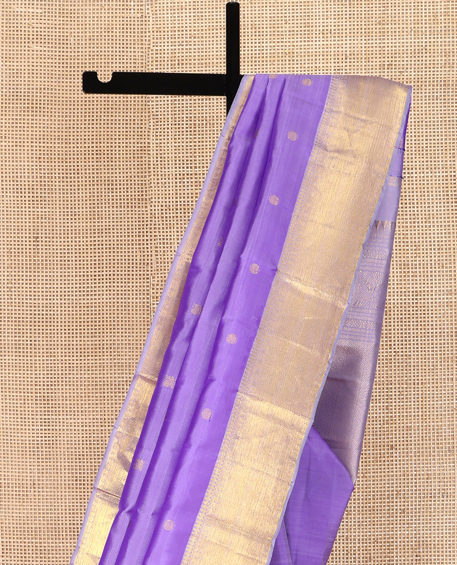 Lavender Kanchipuram Silk Saree, Ornamented with Zari Buttas All Over Its Body, Highlighted by Zari Border of Thilakam Mokku, Poun, and Kathir Designs, Gleaming Pallu, and Paired with a Matching Blouse