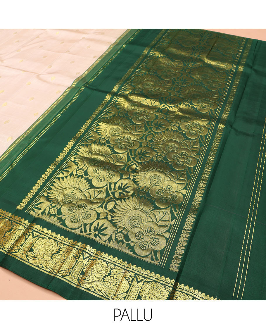 Off-White Kanchipuram Silk Saree, Embellished with Zari Buttas on Its Body, Complemented by a Contrast One-Sided Korvai Border of Salngai, Banaras, and Mayil Designs, Pallu of Floral Zari Designs, and Comes Without a Blouse