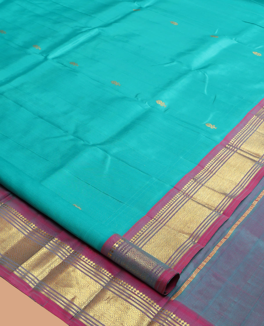 Blue Kanchipuram Silk Saree, Ornamented with Zari Buttas, a Contrast One-Sided Border of Paneer Sombu, Banaras, Muthu and Jaal Design, Zari Design Pallu, and No Blouse