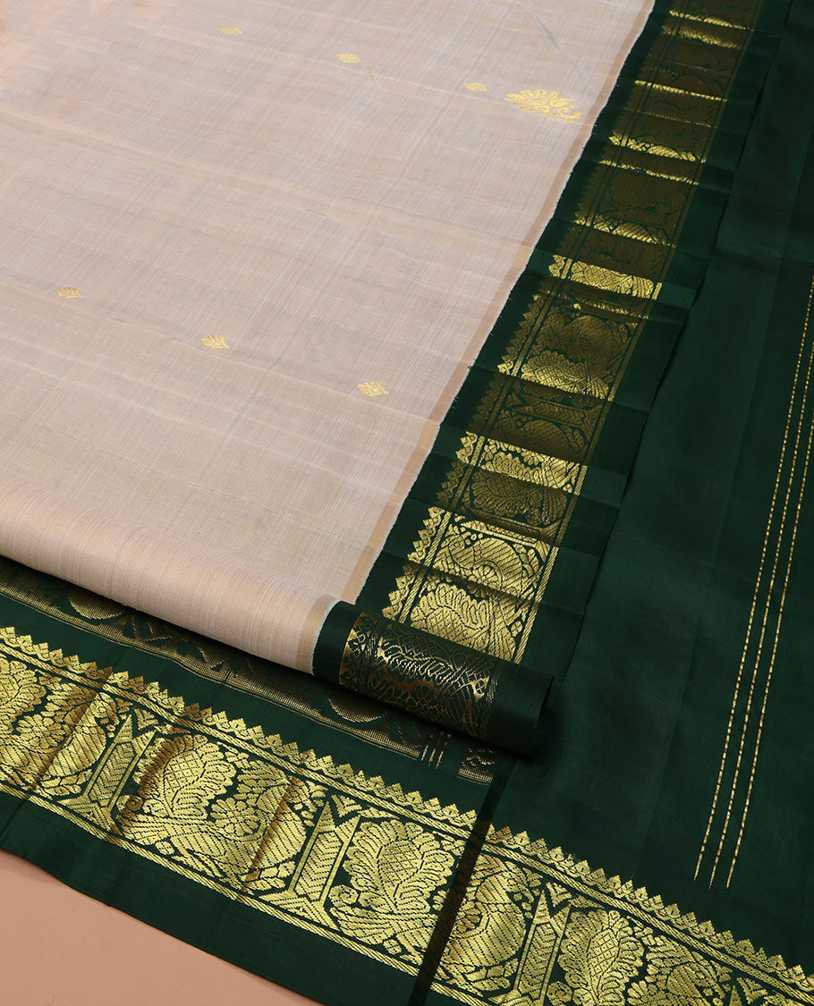 Off-White Kanchipuram Silk Saree, Embellished with Zari Buttas on Its Body, Complemented by a Contrast One-Sided Korvai Border of Salngai, Banaras, and Mayil Designs, Pallu of Floral Zari Designs, and Comes Without a Blouse