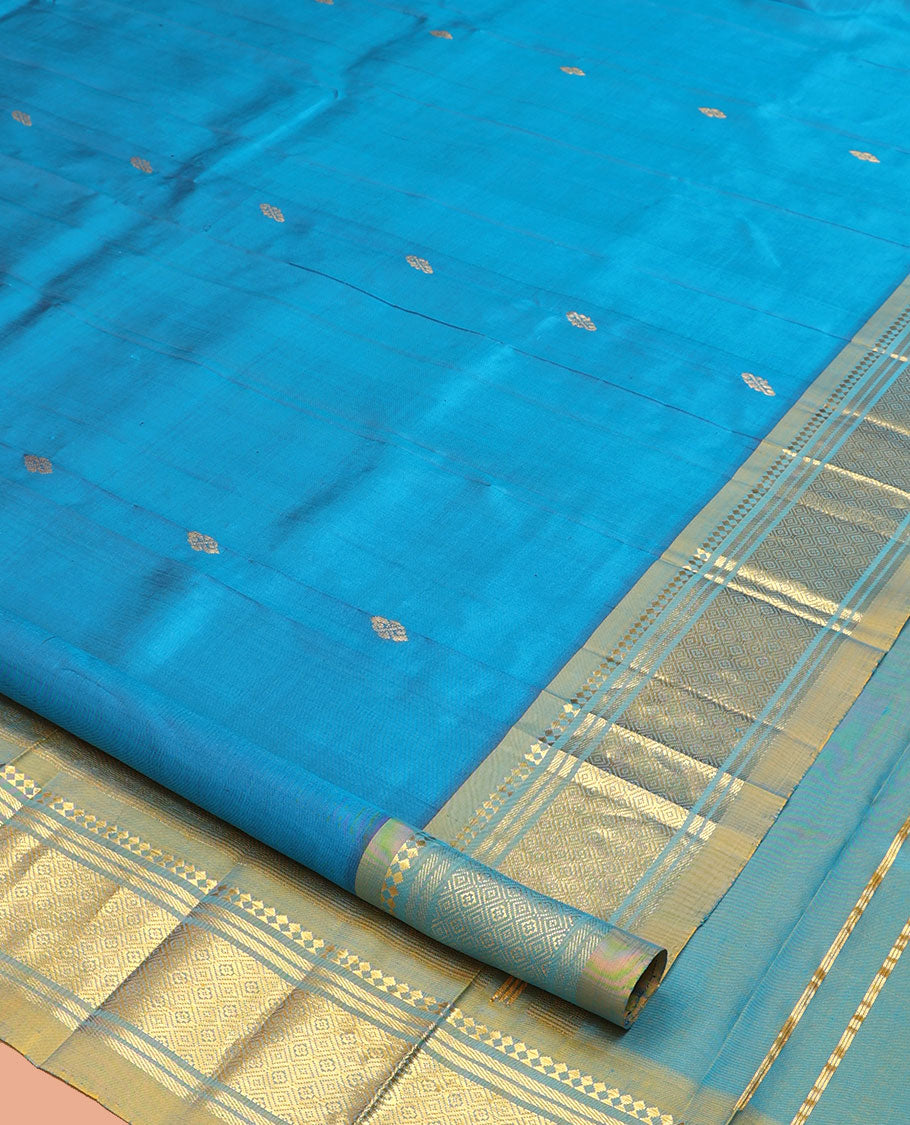 Blue Kanchipuram Silk Saree, Gleamed Up with Zari Buttas, a Contrast One-Sided Border of Panner Sombu, Banaras, and Jaal Designs, a Zari Design Pallu, and No Blouse