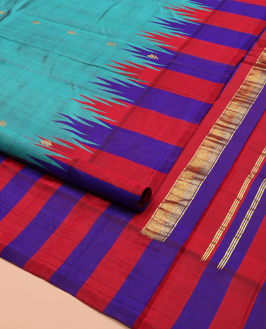 Blue Kanchipuram Silk Saree, Elevated with Zari Buttas on Its Body, Complemented by a Contrast One-Sided Thazampoo Rekku Border of Zari Buttas, Pallu Steeped with Zari Designs, and Comes Without a Blouse