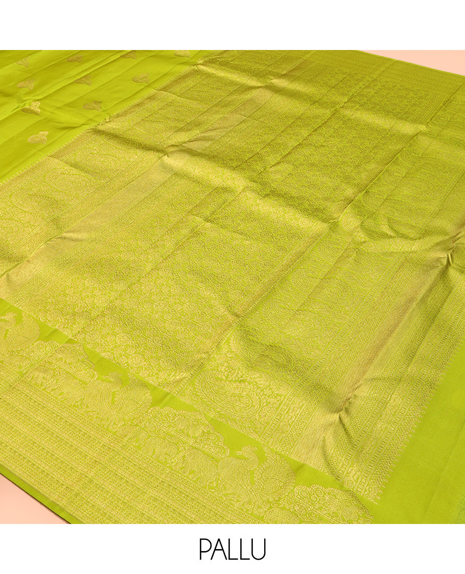 Parrot Green Kanchipuram Silk Saree, Gleamed Up with Zari Buttas All Over Its Body, Highlighted by a Zari Border of Mayil, Yaanai, and Neli Designs, Intricately Designed Pallu, and Paired with a Matching Blouse