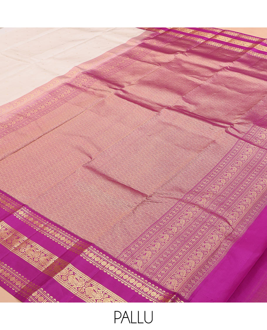 White Vasundhara Silk Saree Elegantly Embellished with Zari Buttas, Complemented by a Varisai Pettu Border Featuring Rekku, Muthu, Banaras, Rudraksham, and Mayil Designs, Majestically Woven with a Zari-Designed Pallu, and Paired with a Contrast Blouse