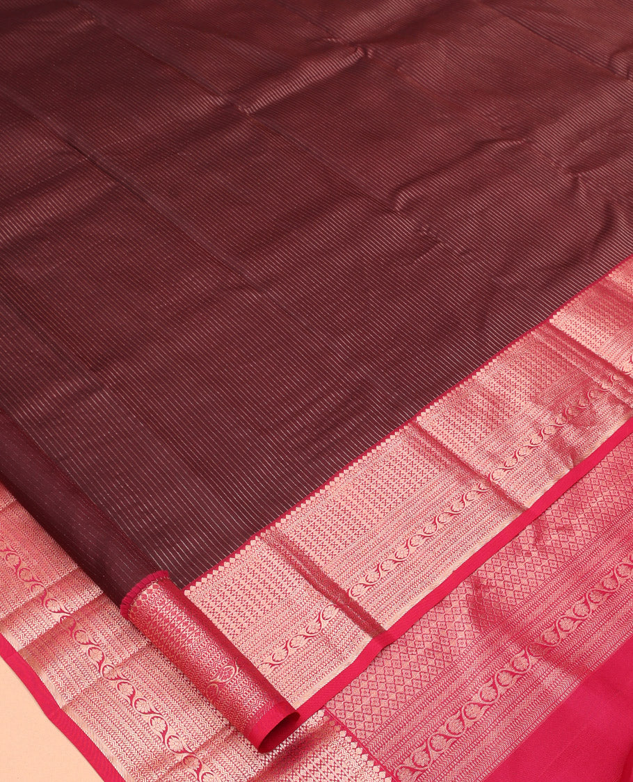 Maroon Vasundhara Silk Saree, Gleamed Up with Vaira Oosi Stripes, a Contrast Border of Thilakam Mokku, Muthu, Rettai Neli, Kathir, and Kodi Visiry Designs, Grand Pallu, and a Contrast Blouse