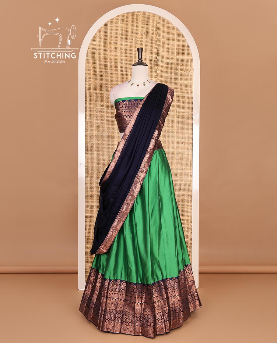 Green taffeta silk half saree, plain with contrast navy blue traditional zari big border, matching zari blouse, and contrast plain zari border dhavani