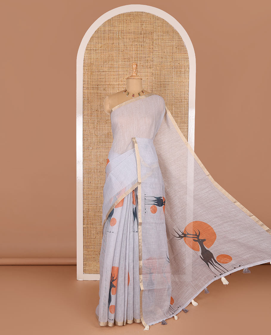 Grey sun and deer silhouette printed linen cotton saree, gold zari piping border, printed pallu, and a matching stripes printed blouse