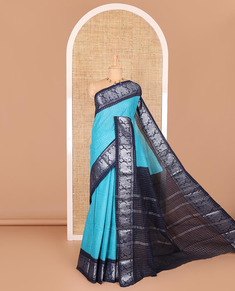 Blue checked sungudi cotton saree, contrast silver zari peacock motif border, striped pallu, and a contrast checked blouse