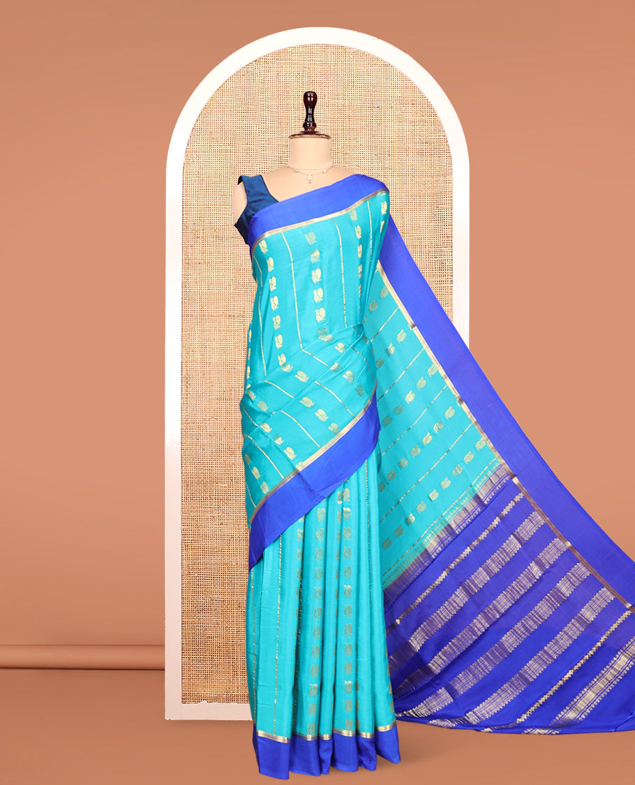 Blue Mysore Silk Saree, Adorned With Zari Stripes and Peacock Buttas Across Its Body, Complemented by Captivating Contrast Border of Traditional Zari Designs, Pallu Steeped with Traditional Zari Designs, and Paired with a Contrast Blouse