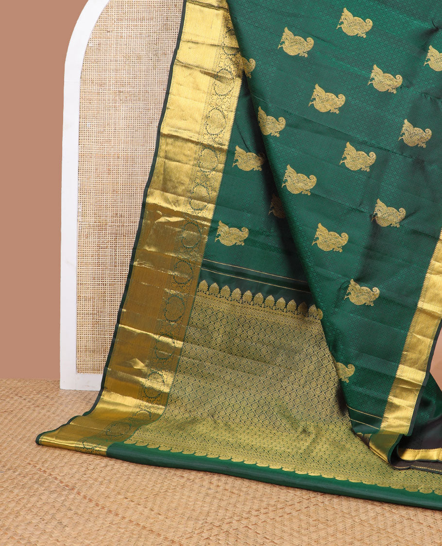 Dark green embossed & mayil buttas silk saree, self-border of thilakam mokku, muthu, poun, banaras design & jaal pallu