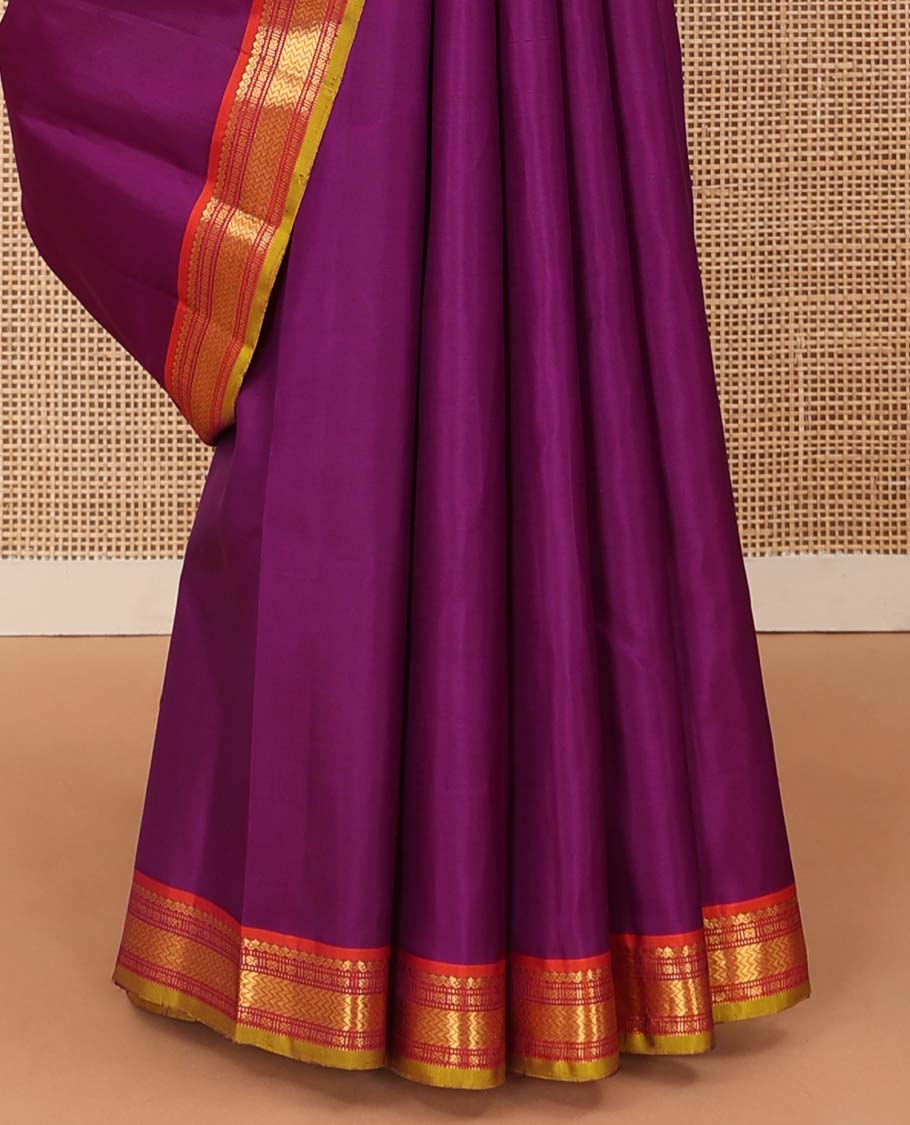 Purple plain Kanchipuram silk saree, contrast border of salngai, muthu, cross kamalam, and vanki designs, and zari design pallu