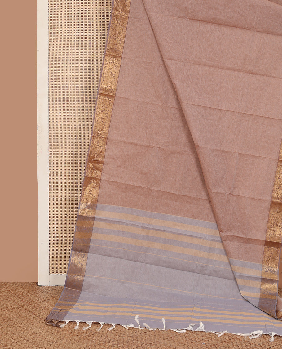 Pale brown plain kanchi cotton saree, contrast traditional zari border, and striped pallu