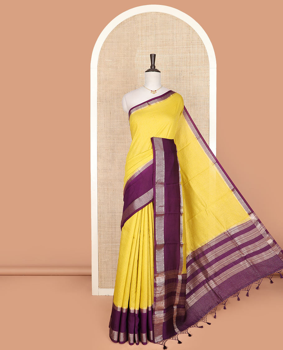 Yellow micro-checked assam silk saree, contrast traditional zari border of floral designs, and zari striped pallu