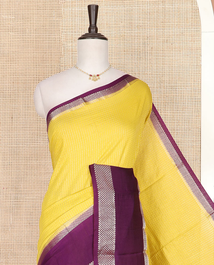 Yellow micro-checked assam silk saree, contrast traditional zari border of floral designs, and zari striped pallu