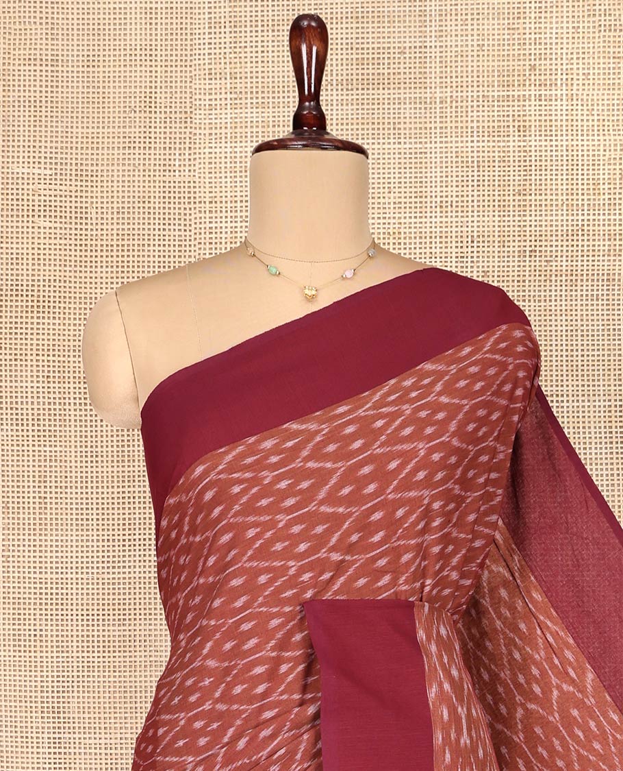 Brown Ikkat Cotton Saree, Steeped with Ikkat-Style Ogee Patterns on Its Body, Complemented by Contrast Border, Pallu Steeped with Ikkat Buttas, and Has No Blouse