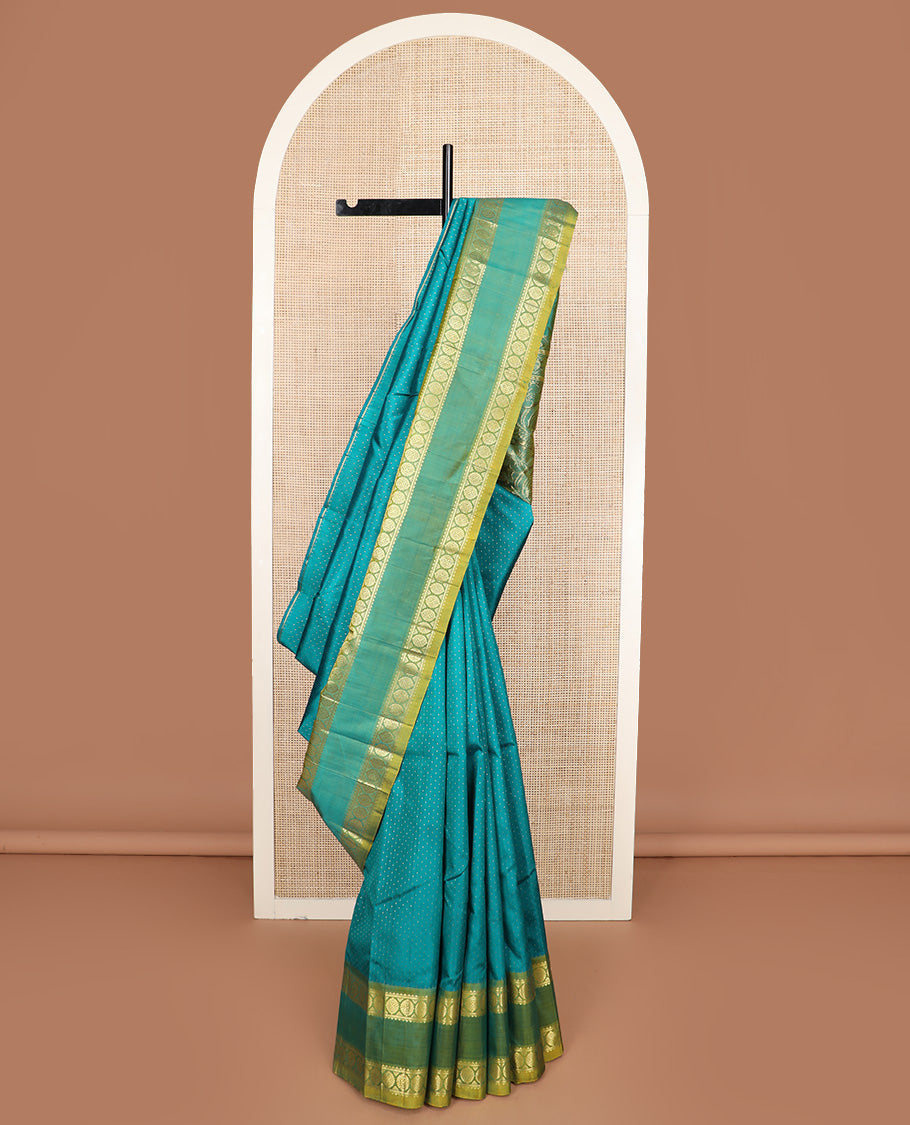 Green zari buttas Kanchipuram silk saree, contrast one-sided rettai pettu border of rekku and poo chakram, and zari design pallu