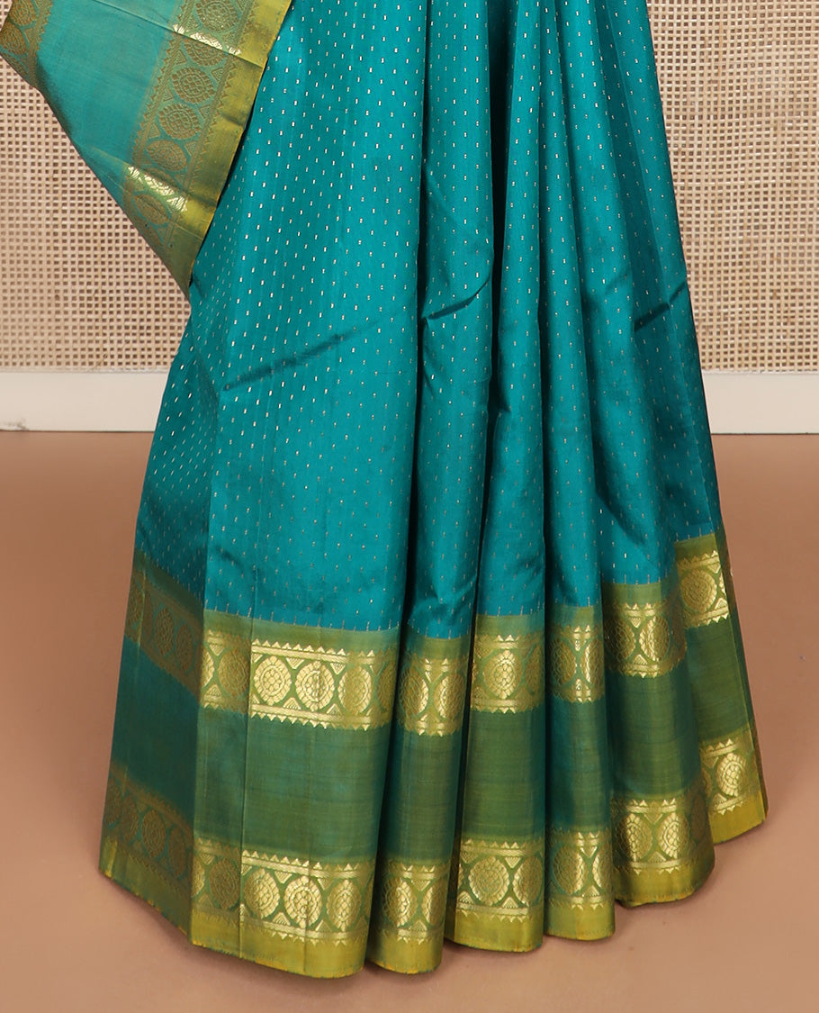 Green zari buttas Kanchipuram silk saree, contrast one-sided rettai pettu border of rekku and poo chakram, and zari design pallu