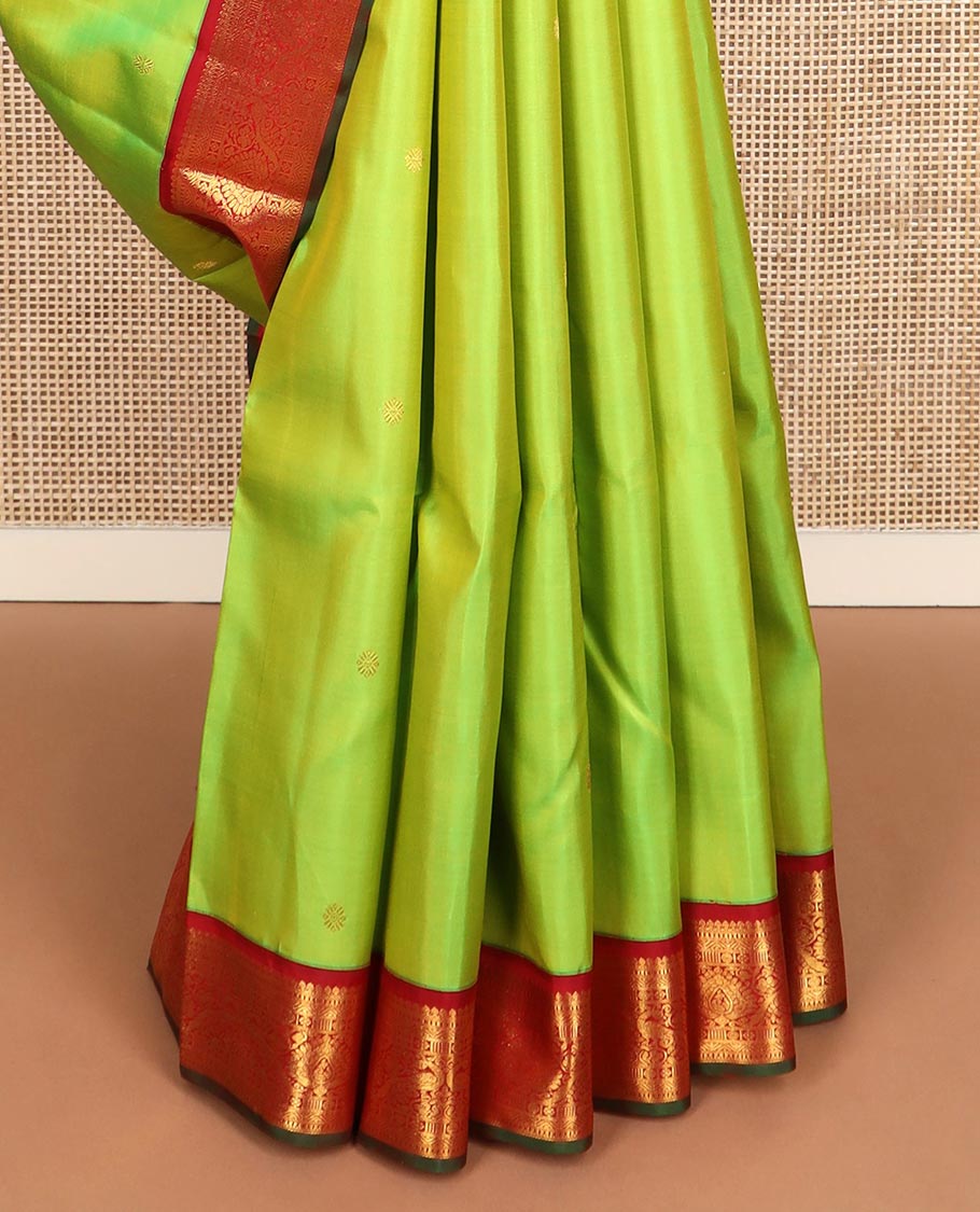 Green zari buttas Kanchipuram silk saree, contrast border of thilakam mokku, rettai neli, and mayil designs, and jaal design pallu