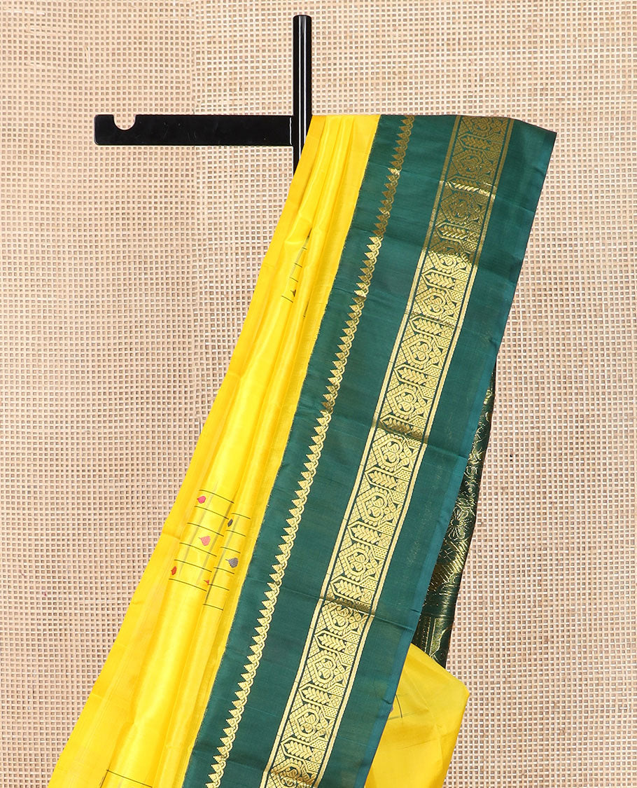 Yellow daayam kattam inspired motifs Kanchipuram silk saree, contrast korvai rettai pettu border of thilakam mokku, and manga designs, and pallu of mayil chariot designs