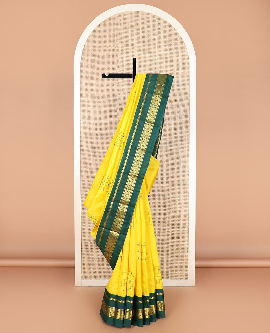 Yellow daayam kattam inspired motifs Kanchipuram silk saree, contrast korvai rettai pettu border of thilakam mokku, and manga designs, and pallu of mayil chariot designs