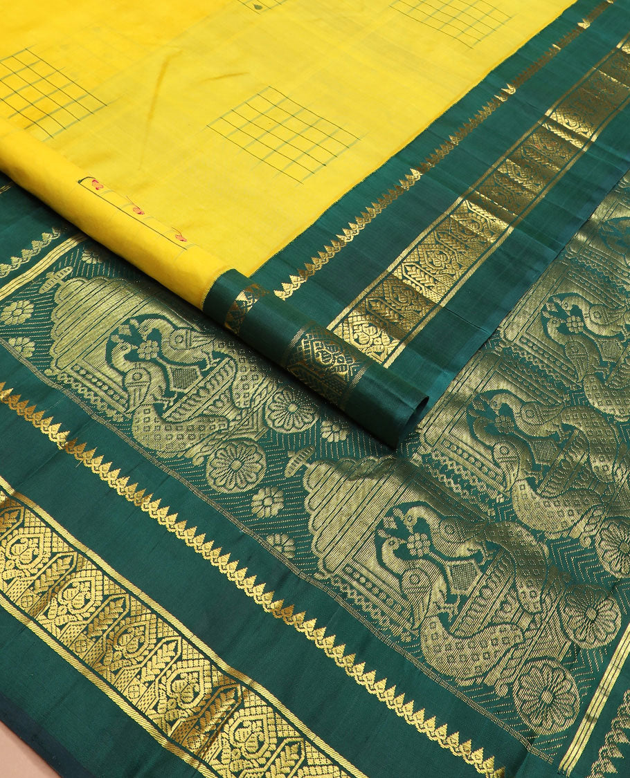 Yellow daayam kattam inspired motifs Kanchipuram silk saree, contrast korvai rettai pettu border of thilakam mokku, and manga designs, and pallu of mayil chariot designs
