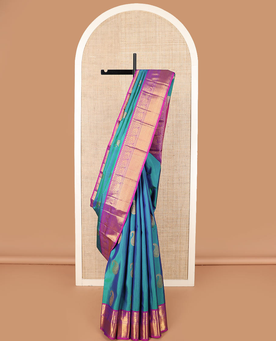 Blue arumbu manga buttas Kanchipuram silk saree, contrast border of manga mokku, muthu, kathir, and mayil designs, and vanki design pallu
